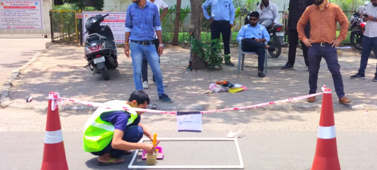 Field team cordoning off a sampling zone on a live city road