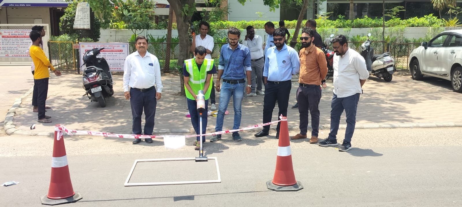 Close-up of the fixed-area quadrat sampling frame being marked on the road